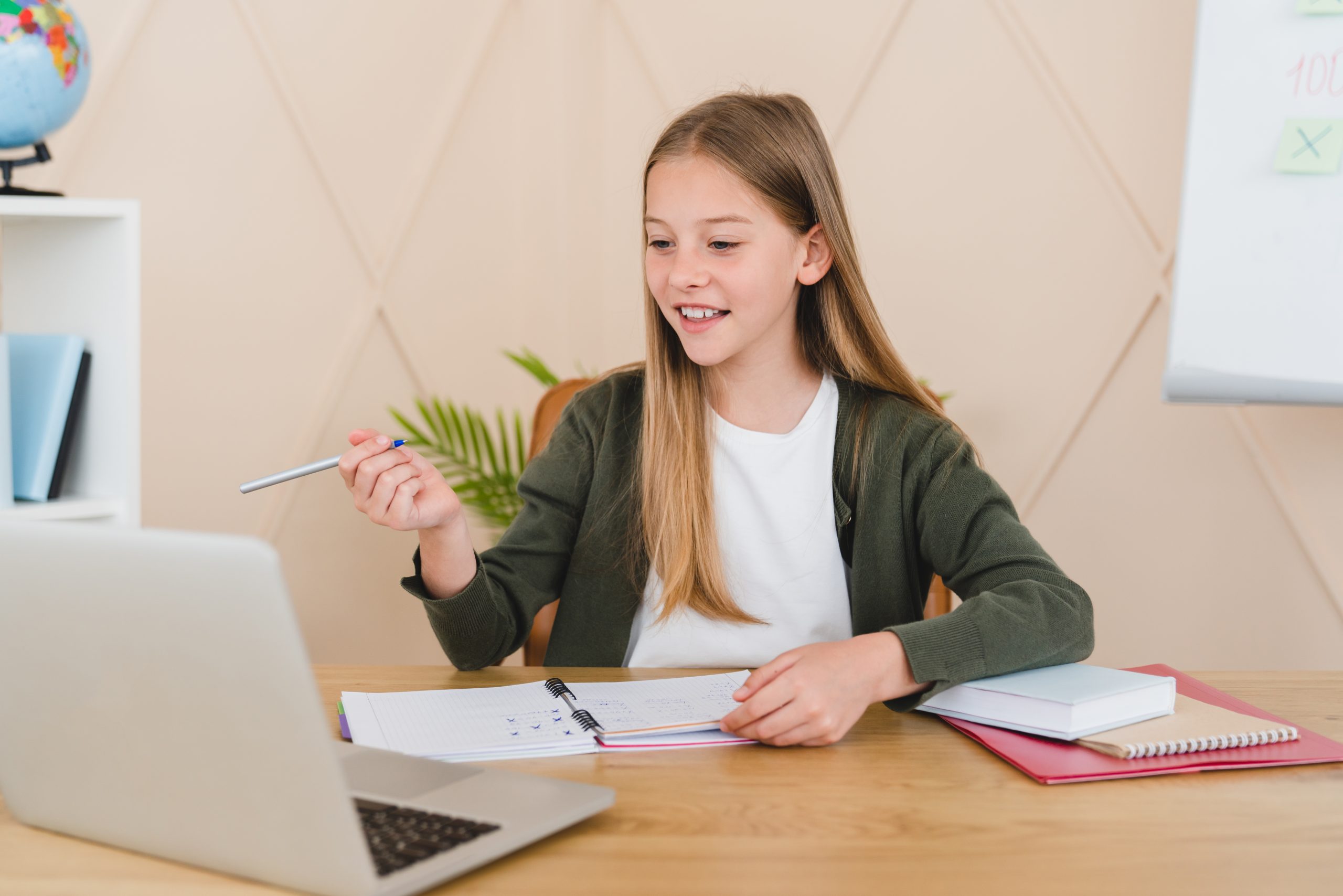Remote education on lockdown, e-learning concept. Young caucasian student schoolgirl pupil having video call lesson online on laptop from home.